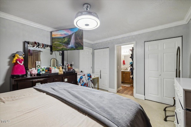 carpeted bedroom featuring ensuite bathroom, ornamental molding, and baseboards