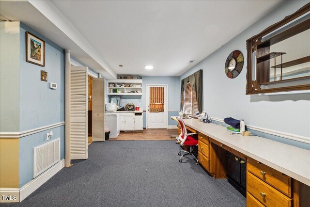 office featuring built in study area, baseboards, carpet, and visible vents