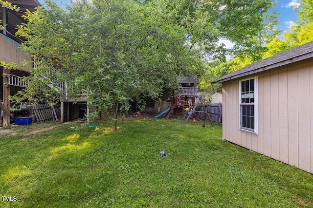 view of yard with a playground and fence