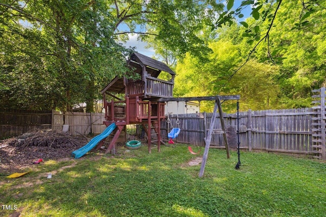 view of playground with a lawn and a fenced backyard