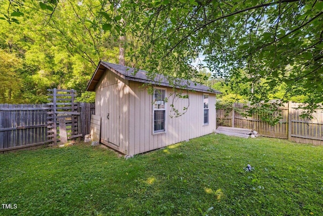 view of outdoor structure with a fenced backyard and an outdoor structure