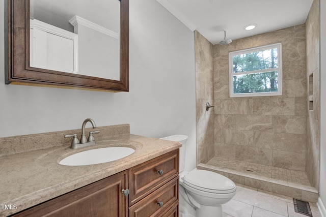 full bath with vanity, toilet, tile patterned floors, visible vents, and tiled shower