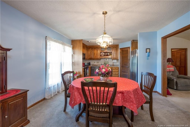 390 Sandy Ridge Rd, Dunn, NC 28334 - dining area with a textured ceiling, baseboards, an inviting chandelier, and light carpet