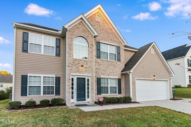 2902 Framer Ln, Durham, NC 27704 - view of front of home with an attached garage, driveway, a front lawn, and brick siding