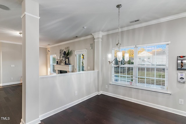 2902 Framer Ln, Durham, NC 27704 - unfurnished dining area featuring ornate columns, dark wood-style floors, ornamental molding, baseboards, and a chandelier