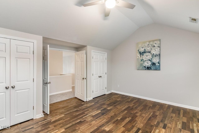 2902 Framer Ln, Durham, NC 27704 - unfurnished bedroom featuring dark wood-style floors, vaulted ceiling, baseboards, and a ceiling fan
