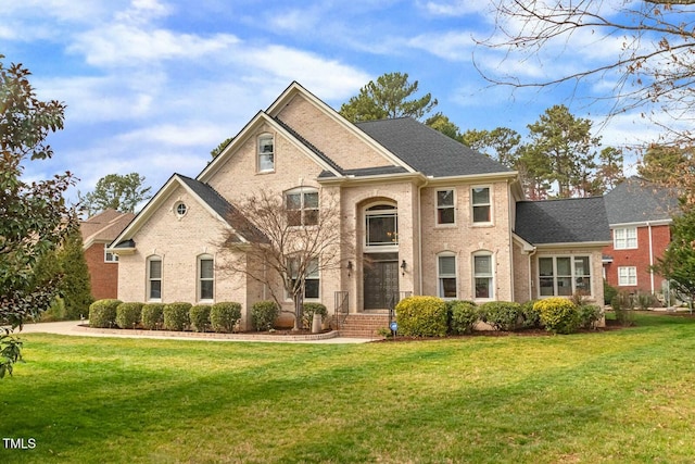 view of front of home featuring a front yard and brick siding