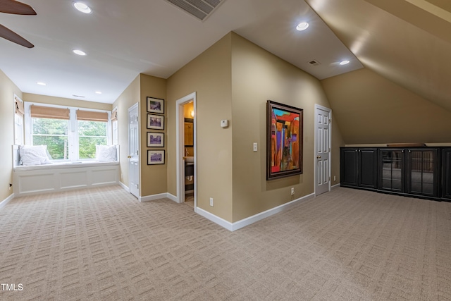 bonus room featuring baseboards, light colored carpet, ceiling fan, and visible vents