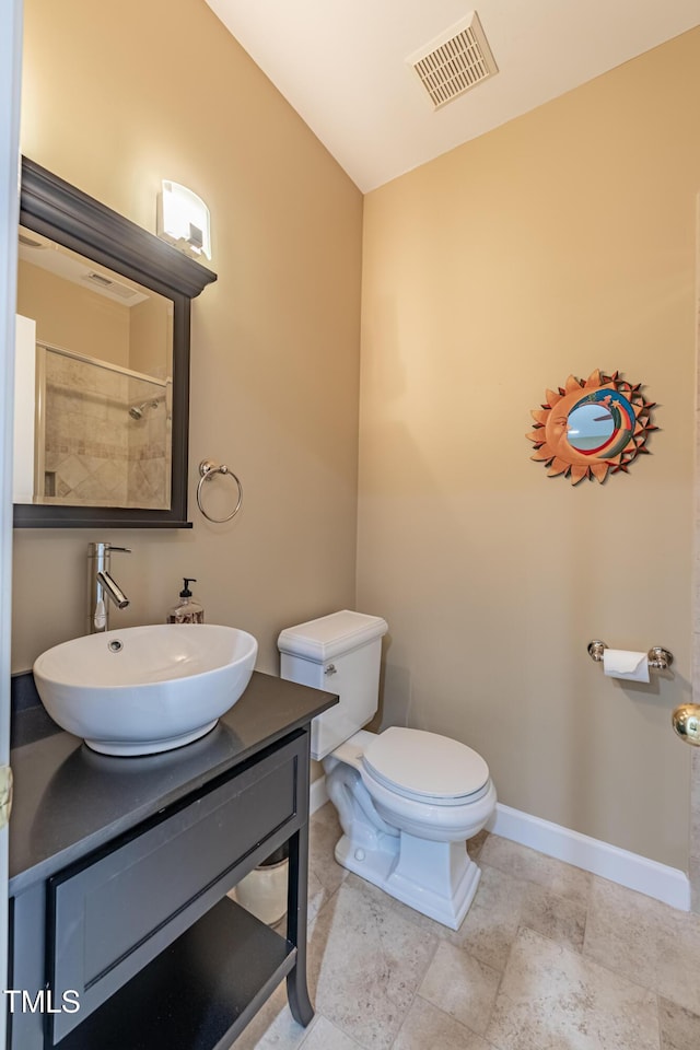 full bathroom with visible vents, vanity, lofted ceiling, toilet, and baseboards
