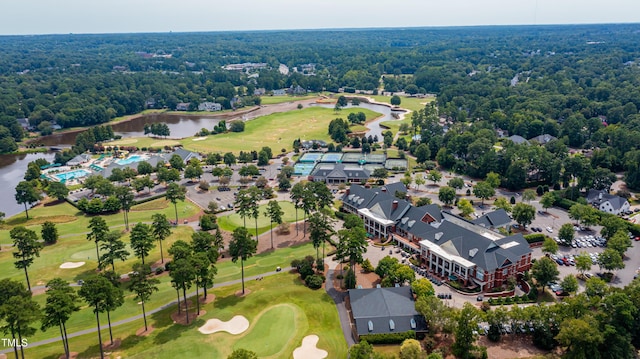 bird's eye view with a water view, view of golf course, and a view of trees