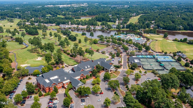 drone / aerial view with a water view and golf course view