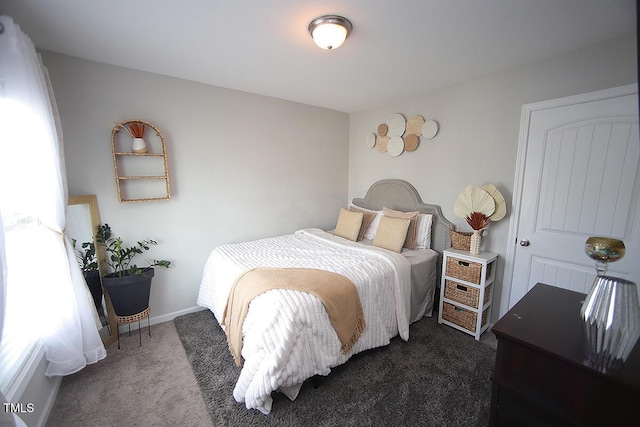 bedroom with dark colored carpet