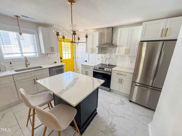 1100 Chester St, Durham, NC 27701 - kitchen with wall chimney range hood, appliances with stainless steel finishes, a sink, marble finish floor, and a kitchen island