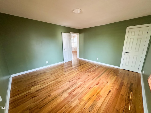 1100 Chester St, Durham, NC 27701 - unfurnished bedroom featuring baseboards and light wood-style flooring
