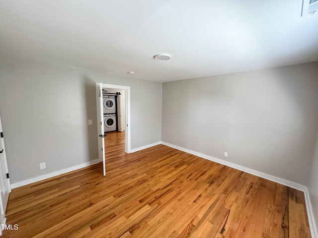 1100 Chester St, Durham, NC 27701 - basement with stacked washer / drying machine, baseboards, and light wood finished floors