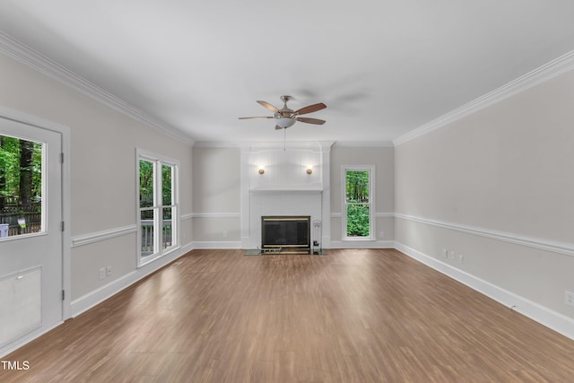 unfurnished living room with baseboards, a ceiling fan, wood finished floors, and a fireplace