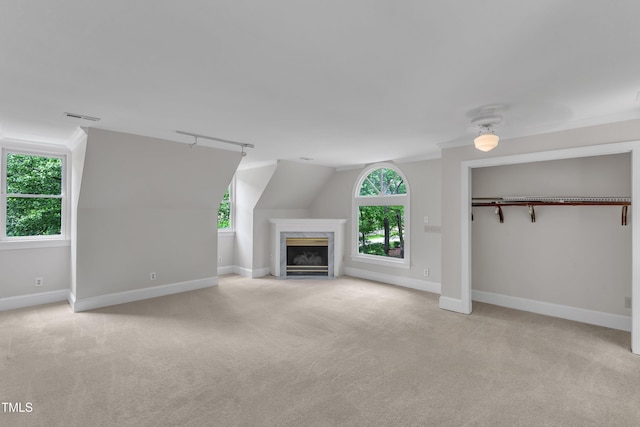 unfurnished living room with carpet floors, baseboards, and visible vents