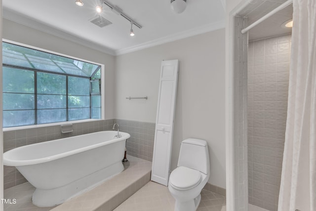 bathroom featuring crown molding, a freestanding bath, tile patterned flooring, toilet, and tiled shower