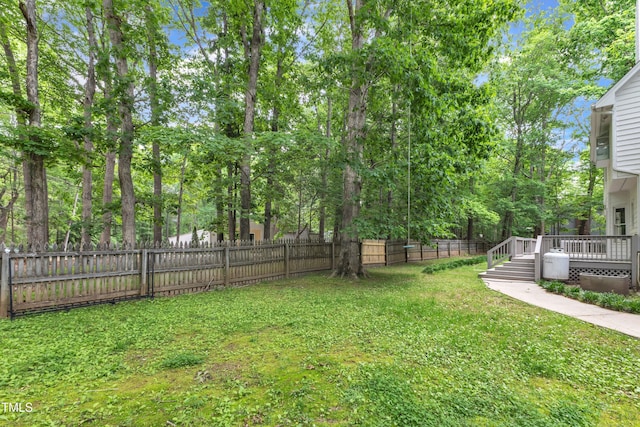 view of yard with a fenced backyard and a wooden deck