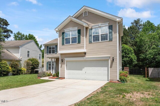8408 Haines Creek Ln, Raleigh, NC 27616 - traditional-style house featuring a garage, a front lawn, fence, and concrete driveway