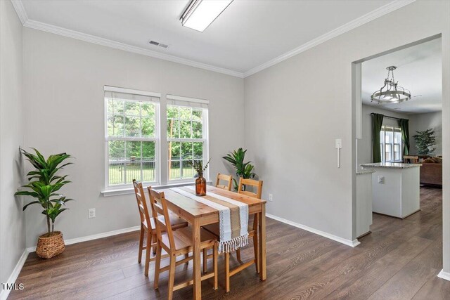 8408 Haines Creek Ln, Raleigh, NC 27616 - dining room featuring crown molding, dark wood-style flooring, and visible vents