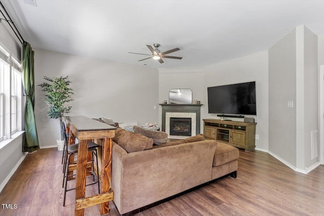 8408 Haines Creek Ln, Raleigh, NC 27616 - living room with a glass covered fireplace, baseboards, ceiling fan, and dark wood-style flooring