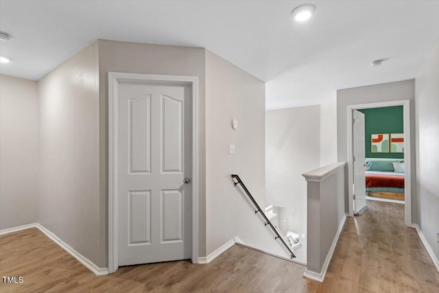 8408 Haines Creek Ln, Raleigh, NC 27616 - hallway featuring baseboards, an upstairs landing, and light wood finished floors