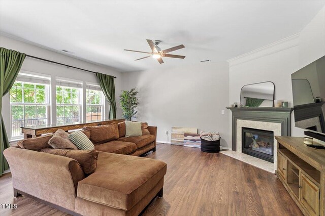 8408 Haines Creek Ln, Raleigh, NC 27616 - living area with crown molding, a premium fireplace, dark wood finished floors, a ceiling fan, and baseboards