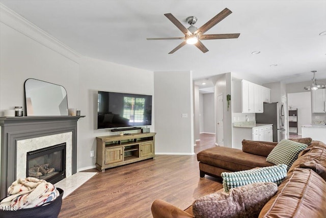 8408 Haines Creek Ln, Raleigh, NC 27616 - living room featuring baseboards, ceiling fan, wood finished floors, and a fireplace