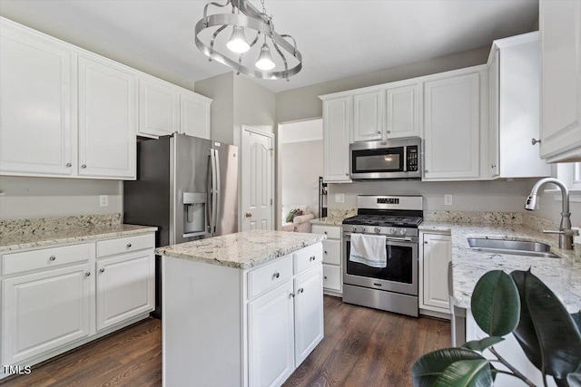 8408 Haines Creek Ln, Raleigh, NC 27616 - kitchen with a sink, stainless steel appliances, dark wood-style flooring, and white cabinetry