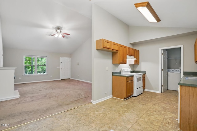 5414 Stanley Rd, Durham, NC 27704 - kitchen featuring electric range, under cabinet range hood, lofted ceiling, and washer / dryer