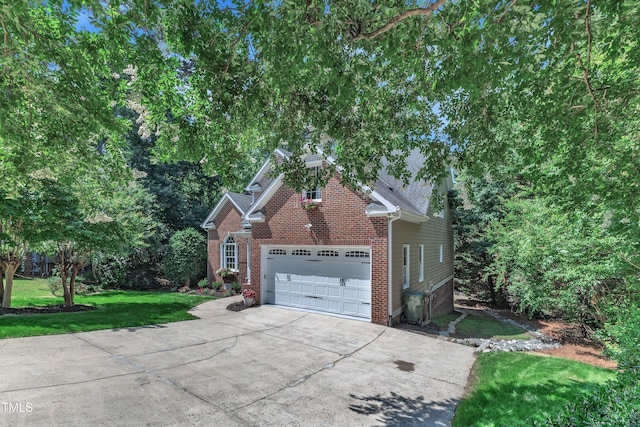 111 Ferncroft Ct, Cary, NC 27519 - view of home's exterior featuring brick siding, driveway, a garage, and a lawn