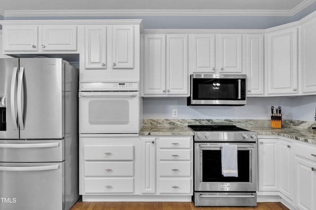 111 Ferncroft Ct, Cary, NC 27519 - kitchen with appliances with stainless steel finishes, white cabinetry, light stone counters, and ornamental molding