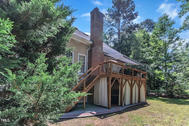 111 Ferncroft Ct, Cary, NC 27519 - rear view of property with a wooden deck, a chimney, a lawn, stairs, and a shingled roof