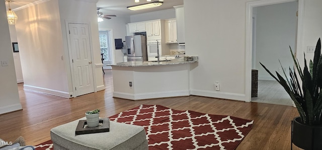 111 Ferncroft Ct, Cary, NC 27519 - kitchen featuring stainless steel fridge with ice dispenser, crown molding, ceiling fan, wood finished floors, and white cabinetry