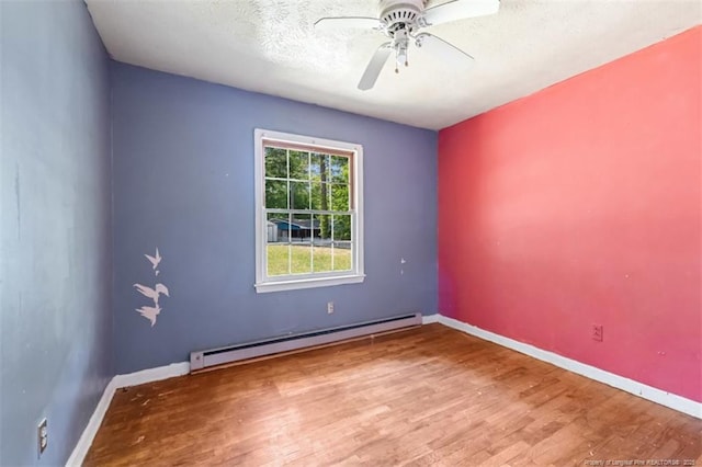 empty room featuring a ceiling fan, a textured ceiling, wood finished floors, baseboards, and a baseboard radiator