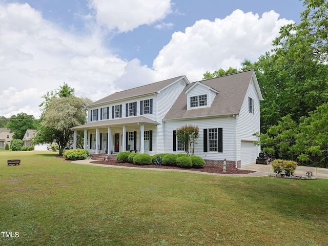 colonial house with covered porch, an attached garage, a shingled roof, concrete driveway, and a front yard