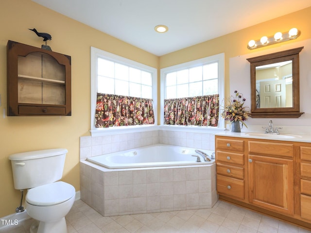 full bath featuring toilet, tile patterned floors, vanity, and a garden tub