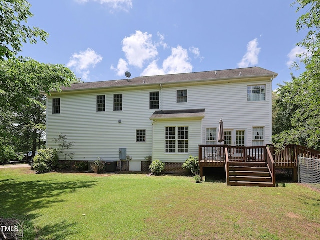 back of property with a yard, a deck, and central air condition unit
