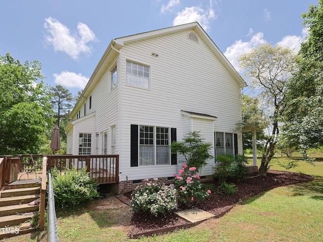 view of home's exterior with a lawn, a wooden deck, and crawl space