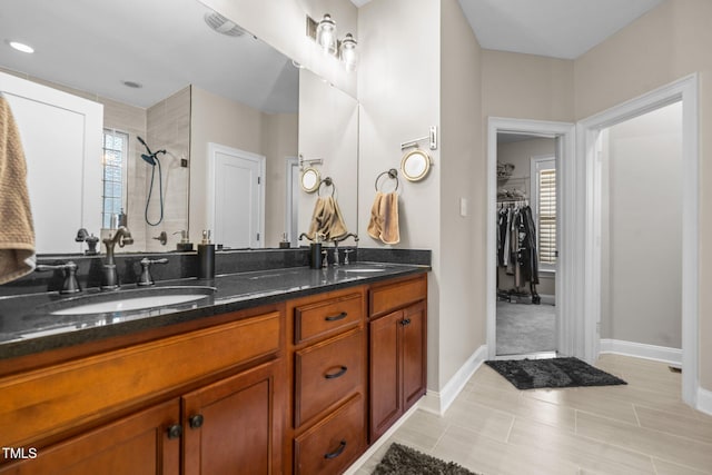 200 Heather Brook Cir, Spring Lake, NC 28390 - full bathroom featuring double vanity, a sink, a walk in closet, and a tile shower