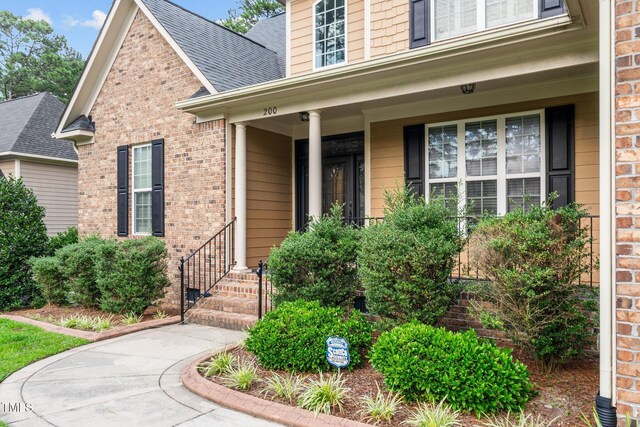 200 Heather Brook Cir, Spring Lake, NC 28390 - entrance to property with covered porch, brick siding, and roof with shingles