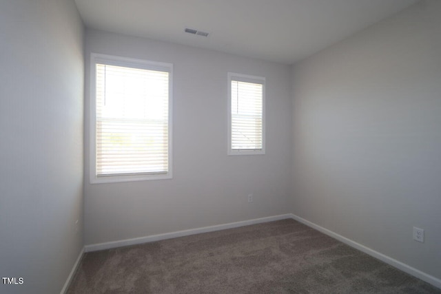 unfurnished room featuring carpet floors, baseboards, and visible vents