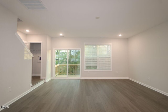unfurnished room featuring recessed lighting, baseboards, dark wood-style flooring, and visible vents