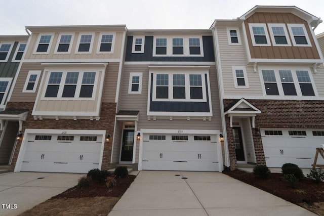 townhome / multi-family property featuring concrete driveway, board and batten siding, and a garage