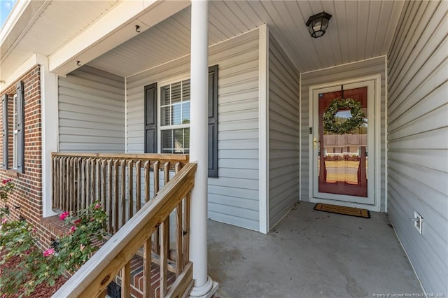 view of exterior entry featuring a porch