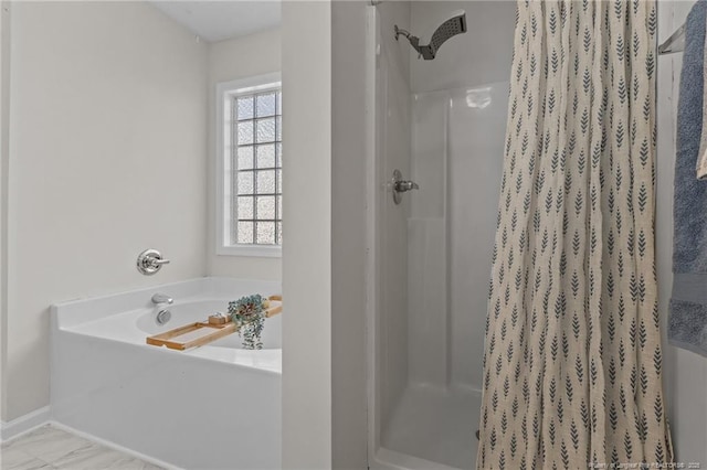 full bath with baseboards, a shower stall, and a garden tub