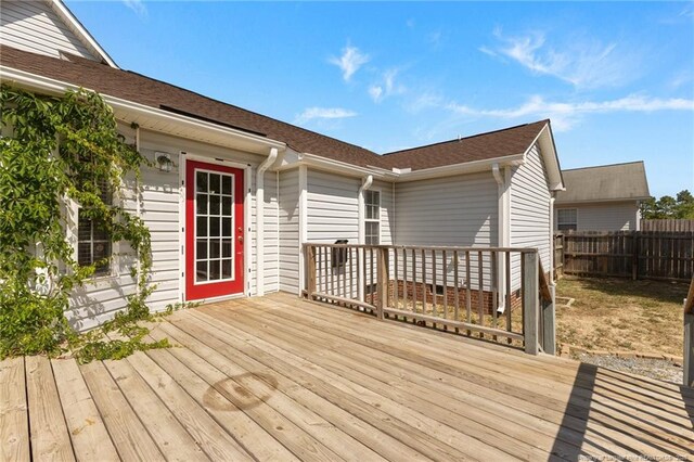 wooden terrace featuring fence