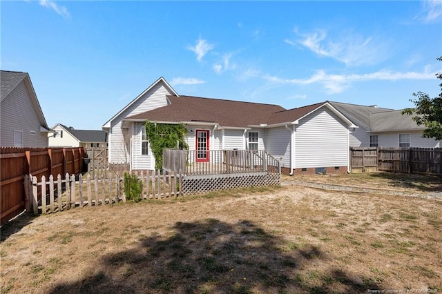 back of property with a lawn, a fenced backyard, and a wooden deck