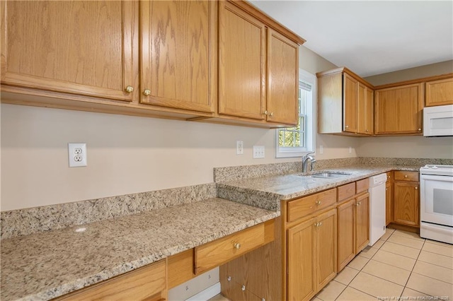 kitchen featuring white appliances, light tile patterned flooring, light stone counters, and a sink